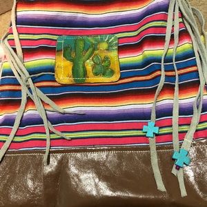 Handmade bag with handtooled patch design.